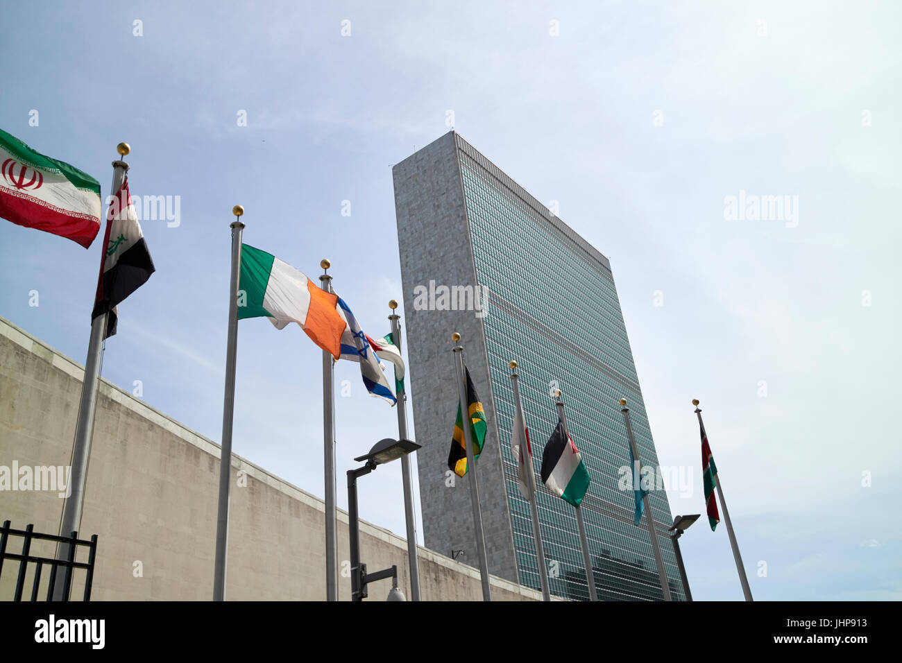 flags flying outside the UN secretariat tower building united nations including ireland New York City USA Stock Photo