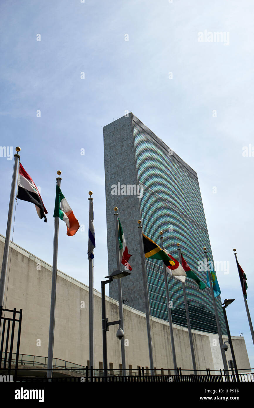 flags flying outside the UN secretariat tower building united nations New York City USA Stock Photo
