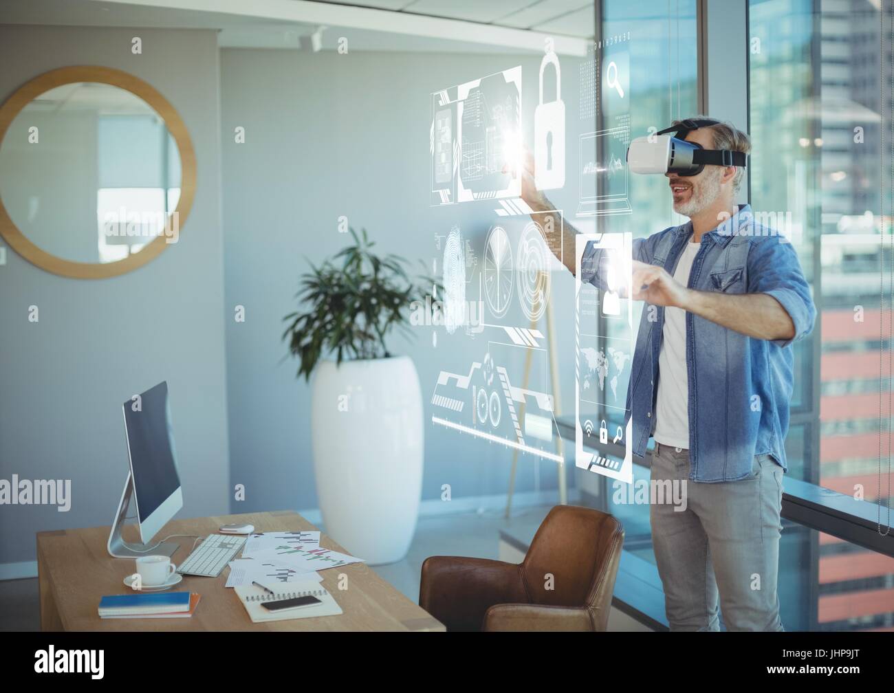 Digital composite of Man in VR headset touching interface Stock Photo ...