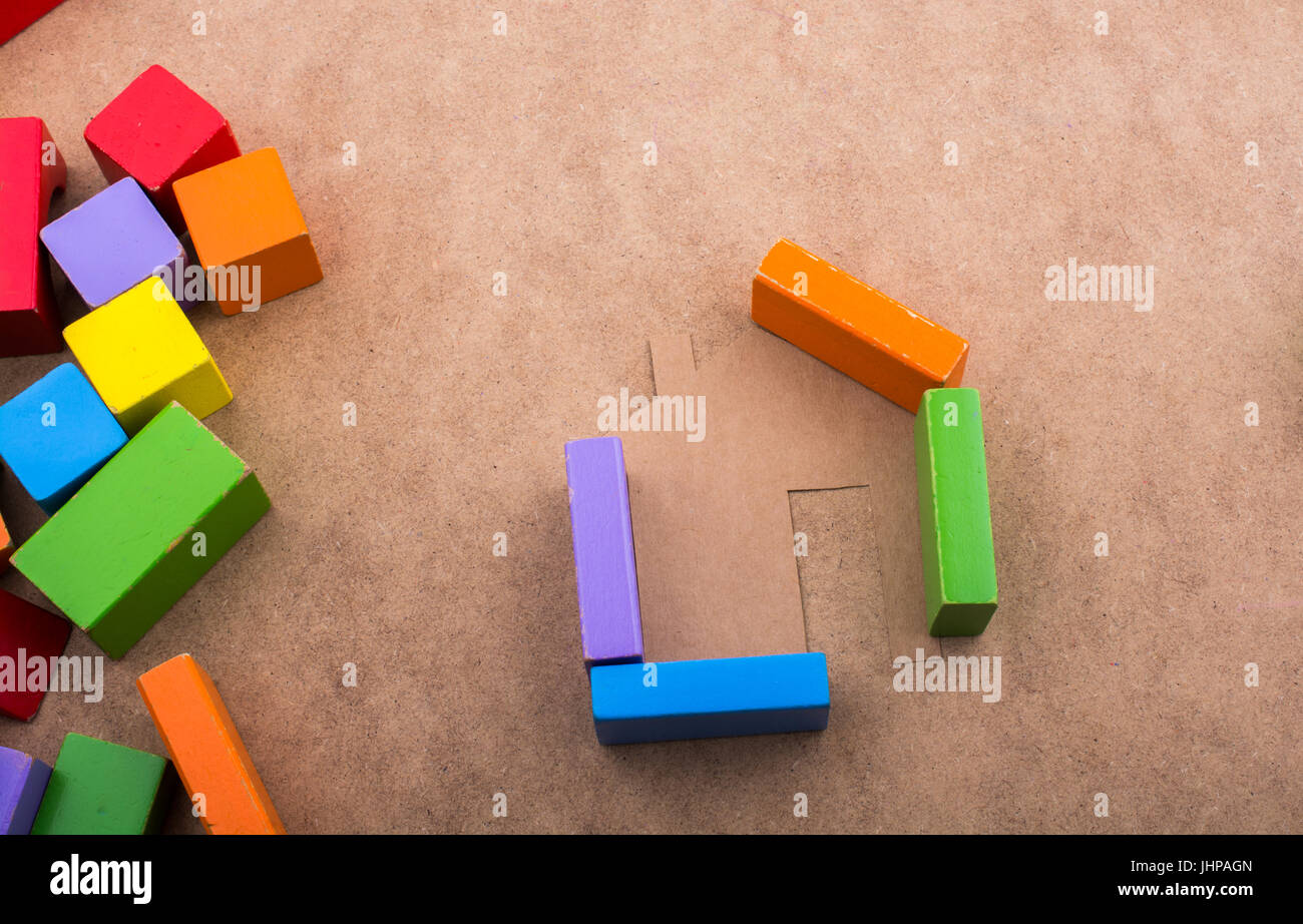House shape formed out of building blocks on a brown background Stock ...