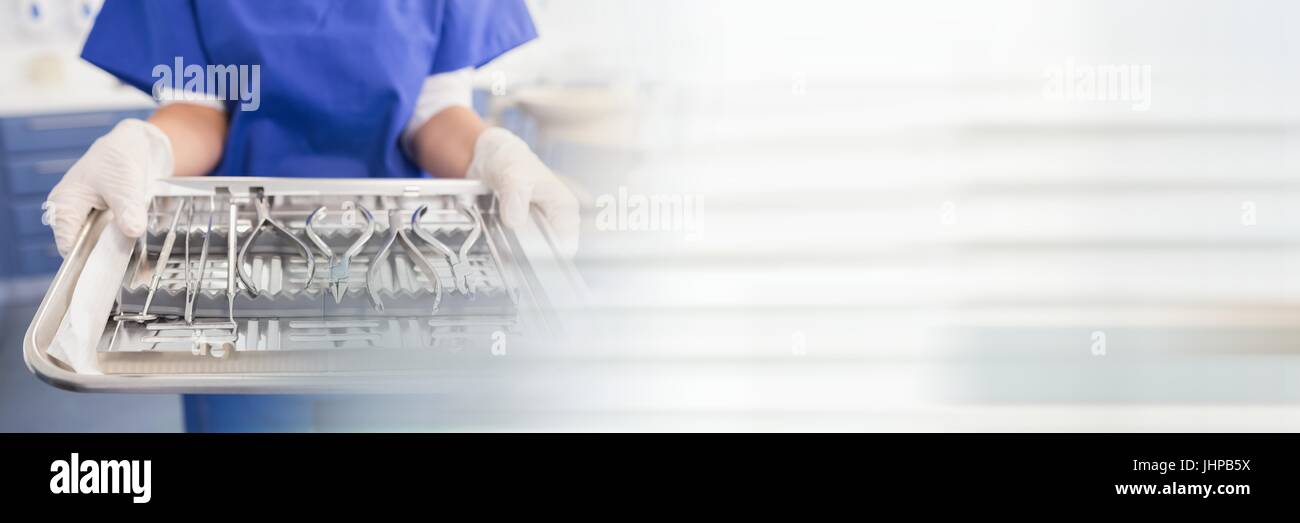 Digital composite of Close up of dentist with tray and blurry white transition Stock Photo