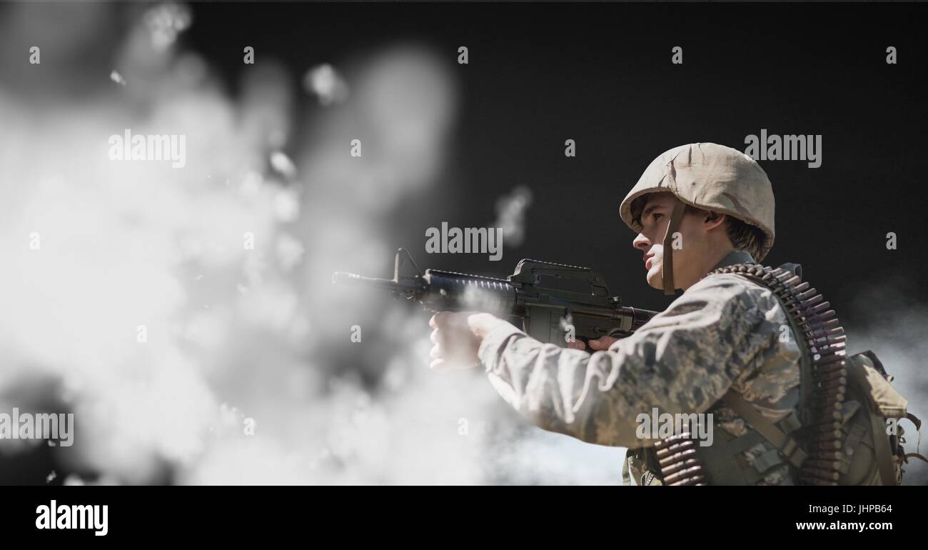Digital composite of Soldier man holding a weapon against black ...