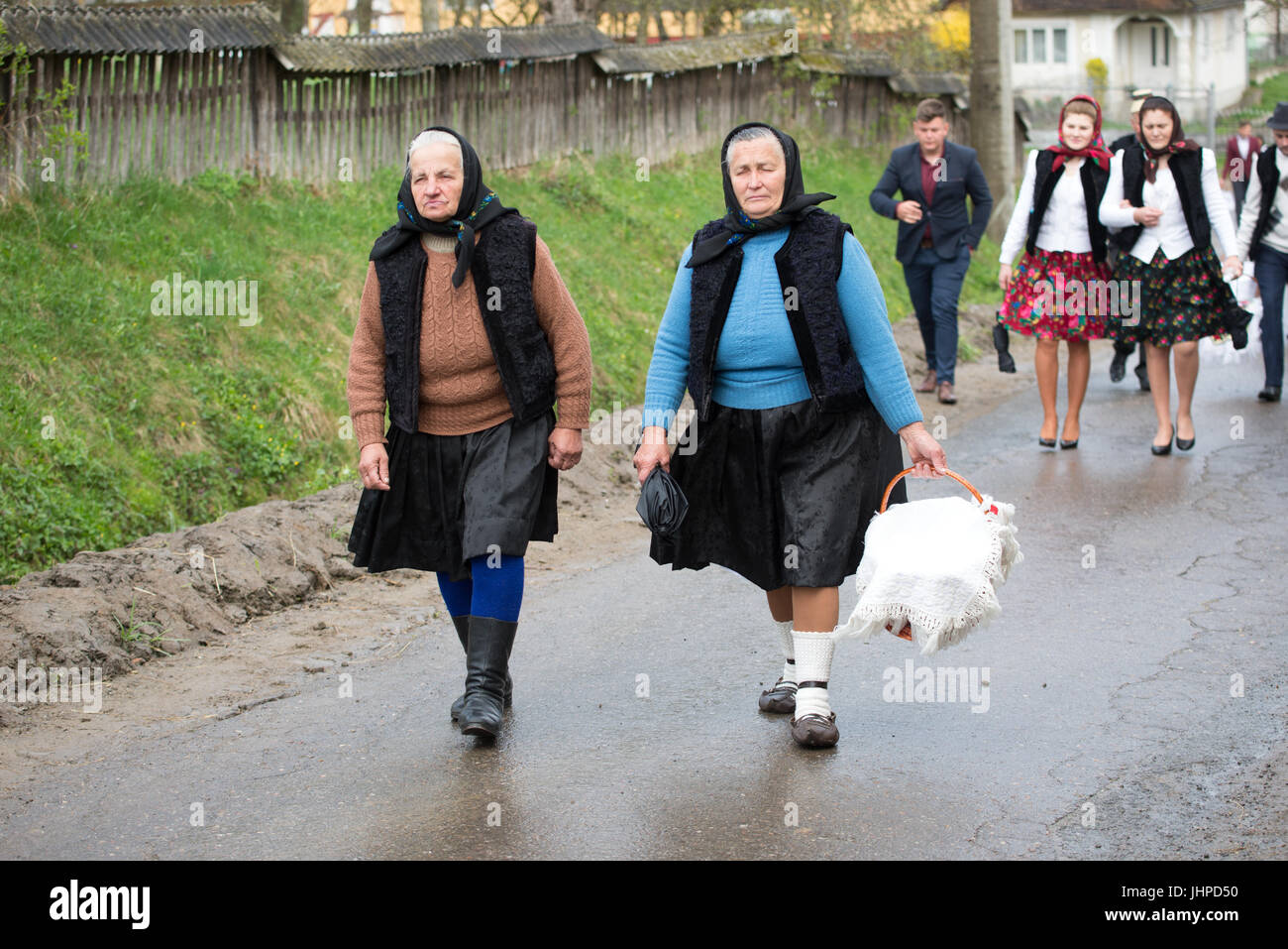 Women going to church for Easter mass with food to be blessed, village of Breb, district of Maramures, Romania Stock Photo