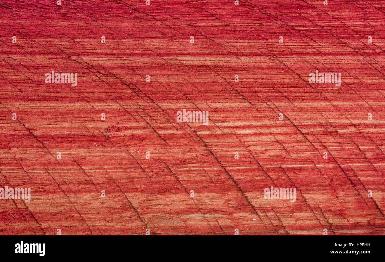 Red painted rough wood plank , with stripes, patterns and lines Stock Photo