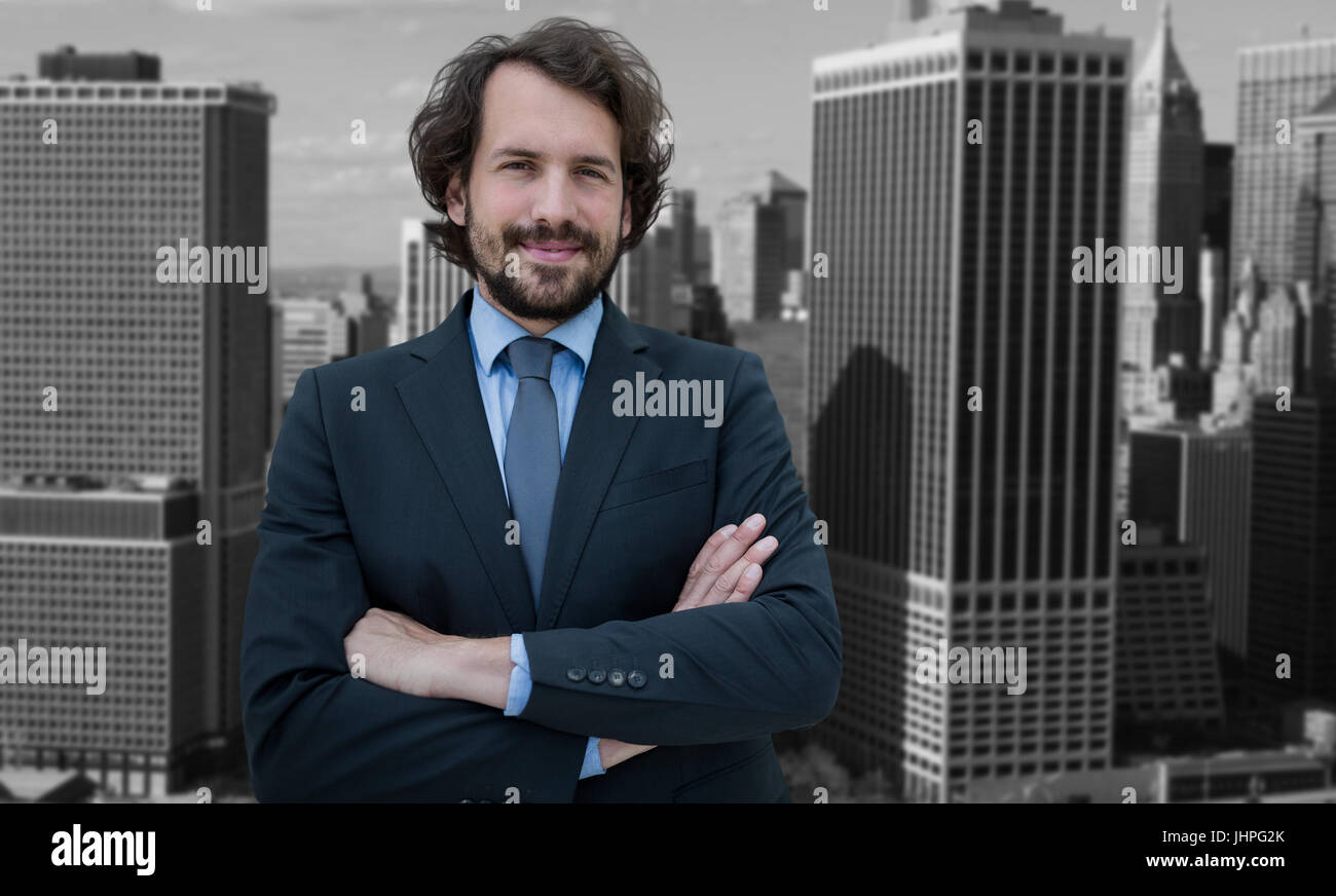 Portrait of businessman standing with arms crossed against high angle ...