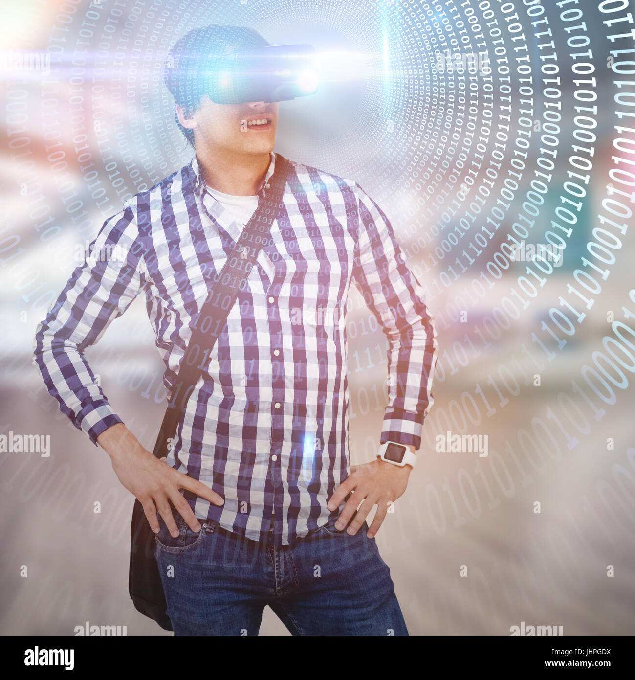 Young man with hand on hop wearing virtual reality simulator glasses ...