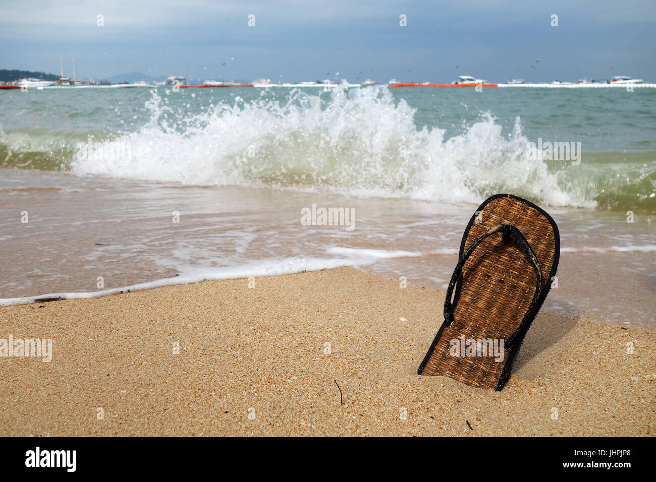 Beach slippers on a sandy beach in Pattaya, Thailand Stock Photo - Alamy