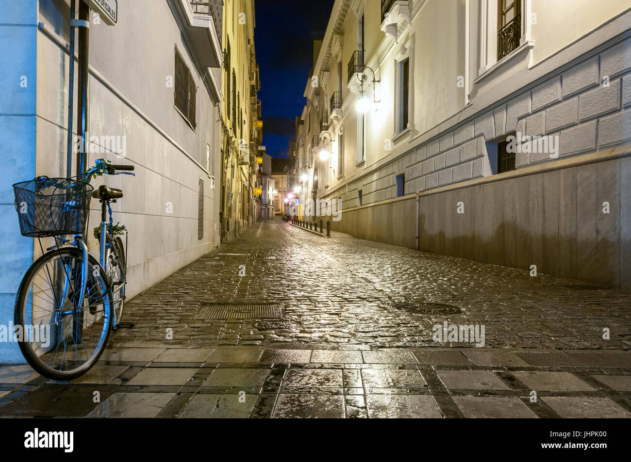 A cobbled stone street taken at night in Granada, Spain Stock Photo - Alamy
