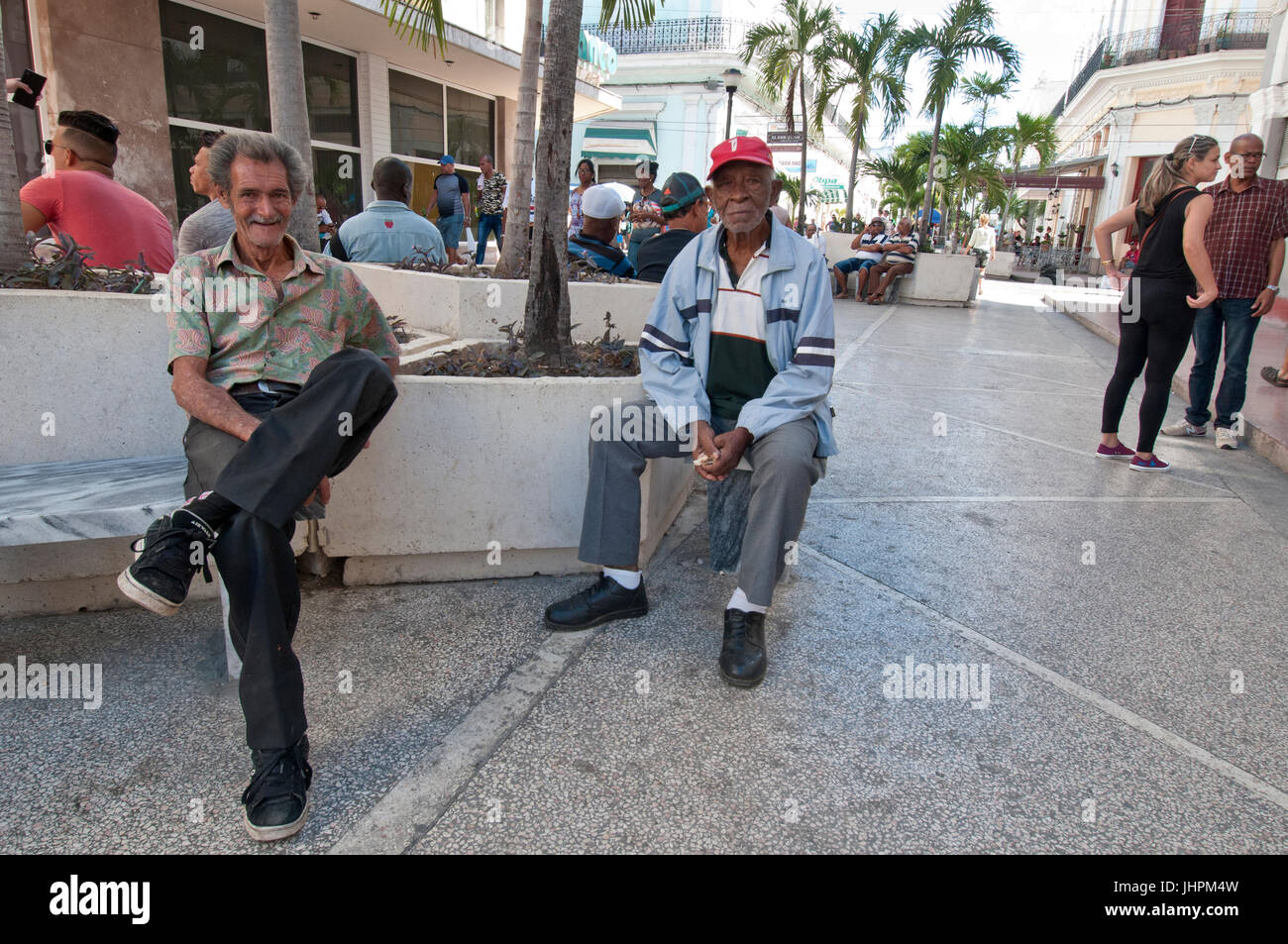 Two Cuban gentlemen sitting in downtown Cienfuegos Cuba Stock Photo