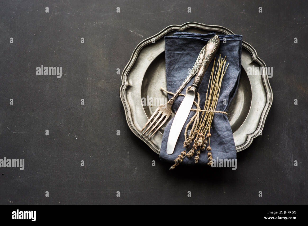 Table setting with dried lavender flowers in vintage style on dark table Stock Photo