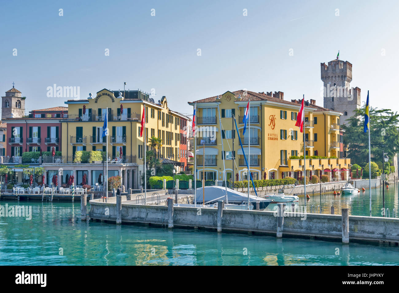 LAKE GARDA SIRMIONE LAKESIDE FRONT APPROACHED BY BOAT WITH HOTELS NEXT TO THE HARBOUR Stock Photo