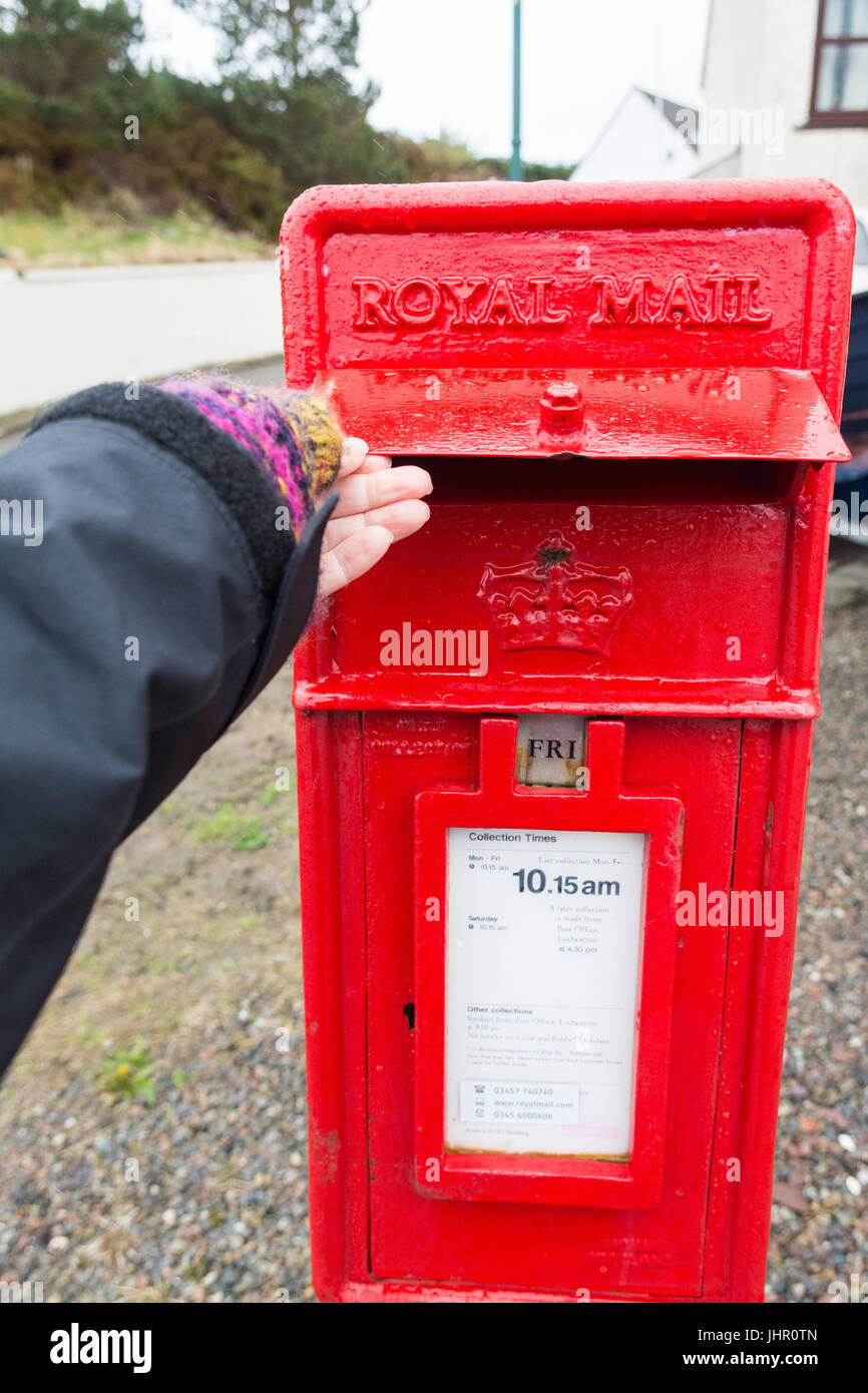 post box in Scottish Highlands with storm flap to protect against bad weather Stock Photo