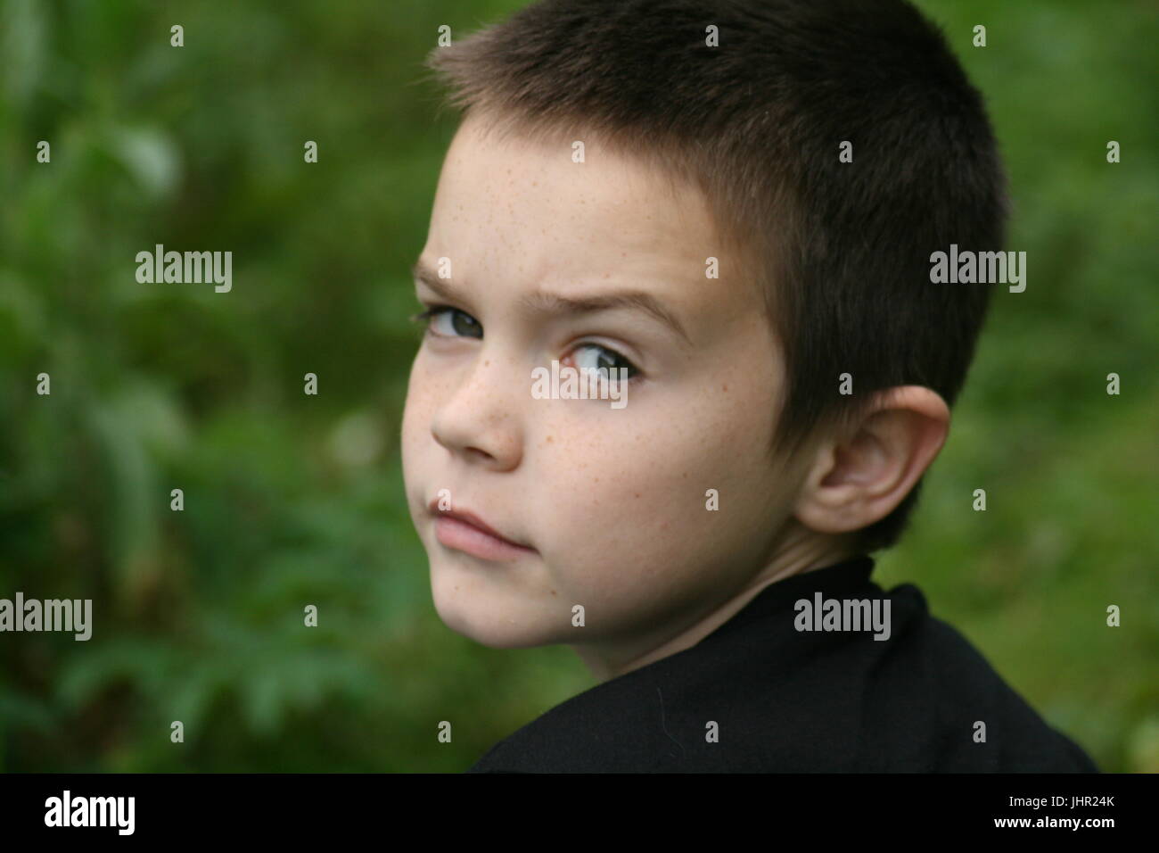 Boy looking over his shoulder Stock Photo