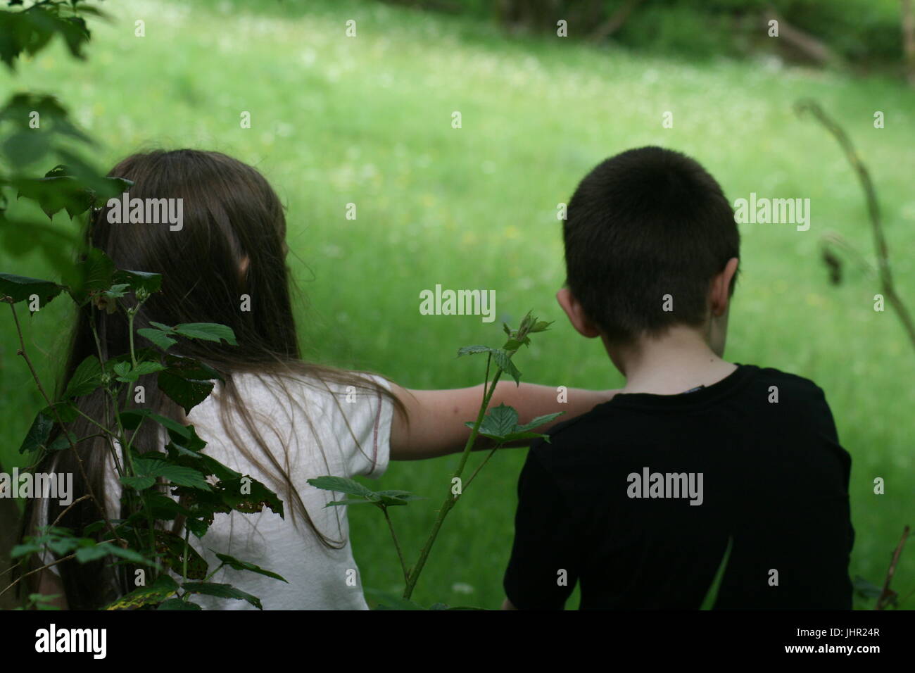 brother and sister sat together outside Stock Photo - Alamy