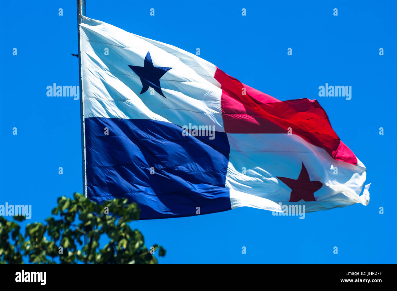 National flag of Panama flying in the wind with blue sky in the background from the Ancon Hill in Panama City Stock Photo