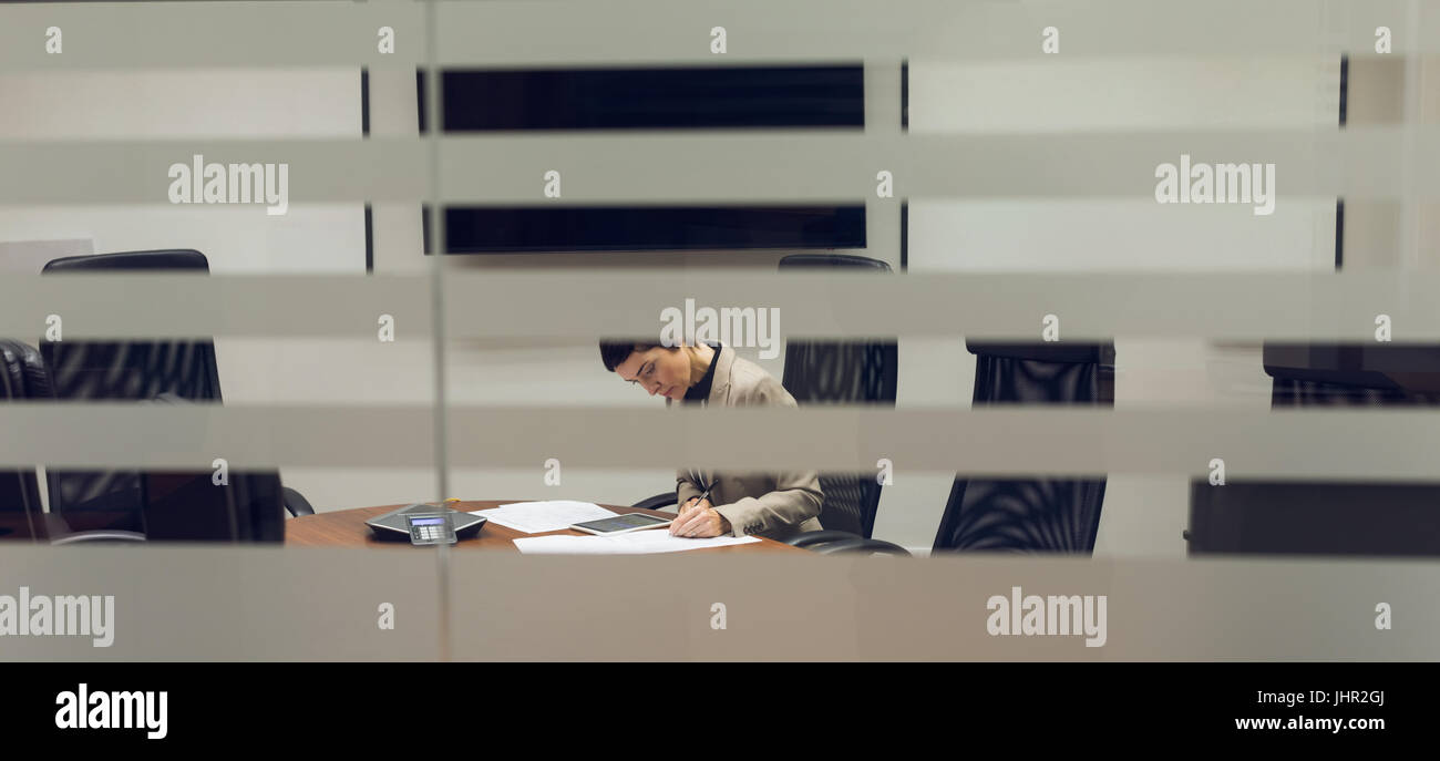 Businesswoman working at her desk in office Stock Photo - Alamy