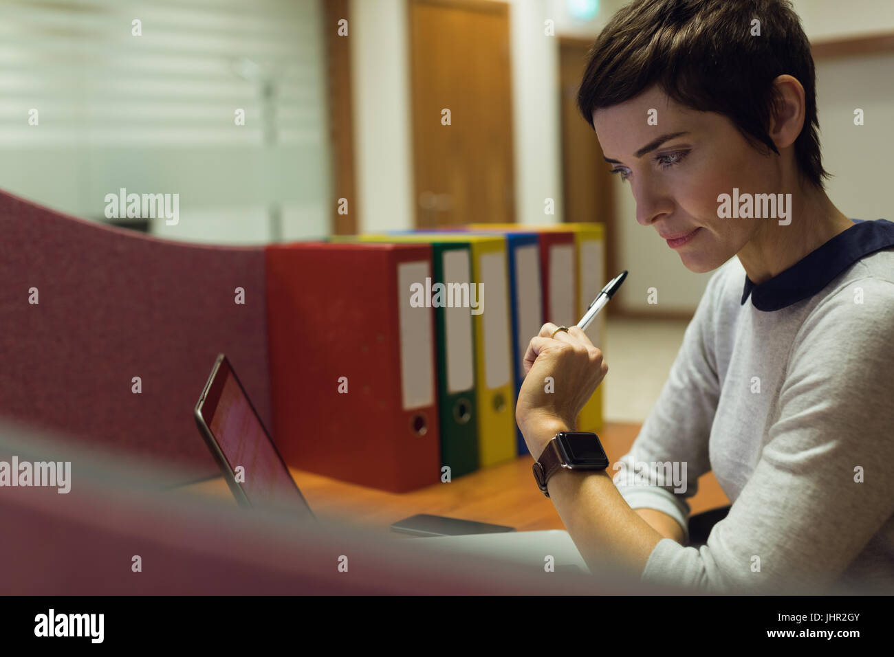 Businesswoman working at her desk in office Stock Photo - Alamy