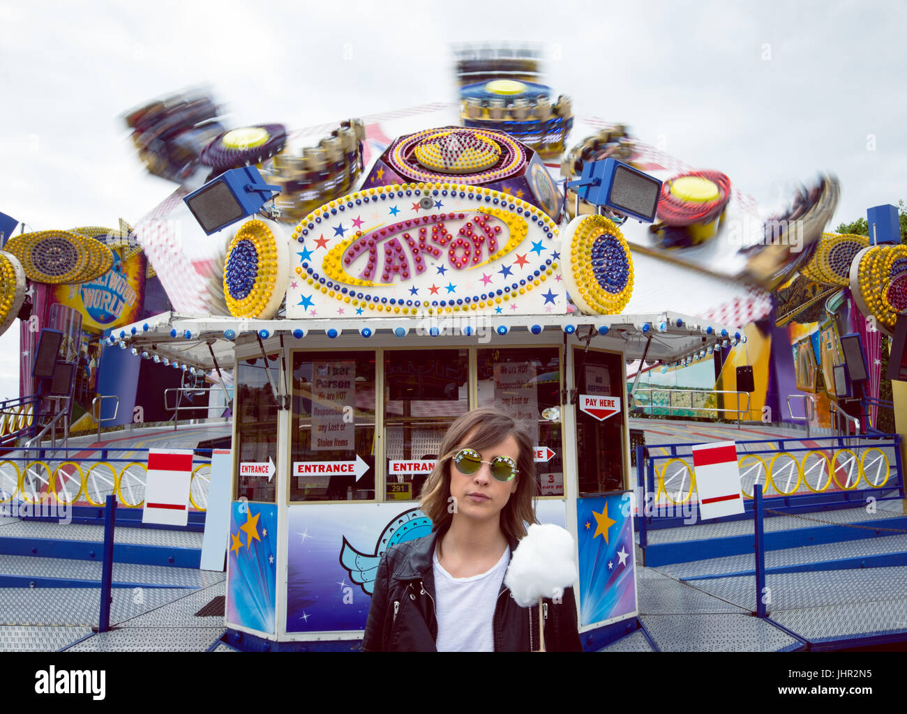 Beautiful woman holding cotton candy in amusement park Stock Photo - Alamy