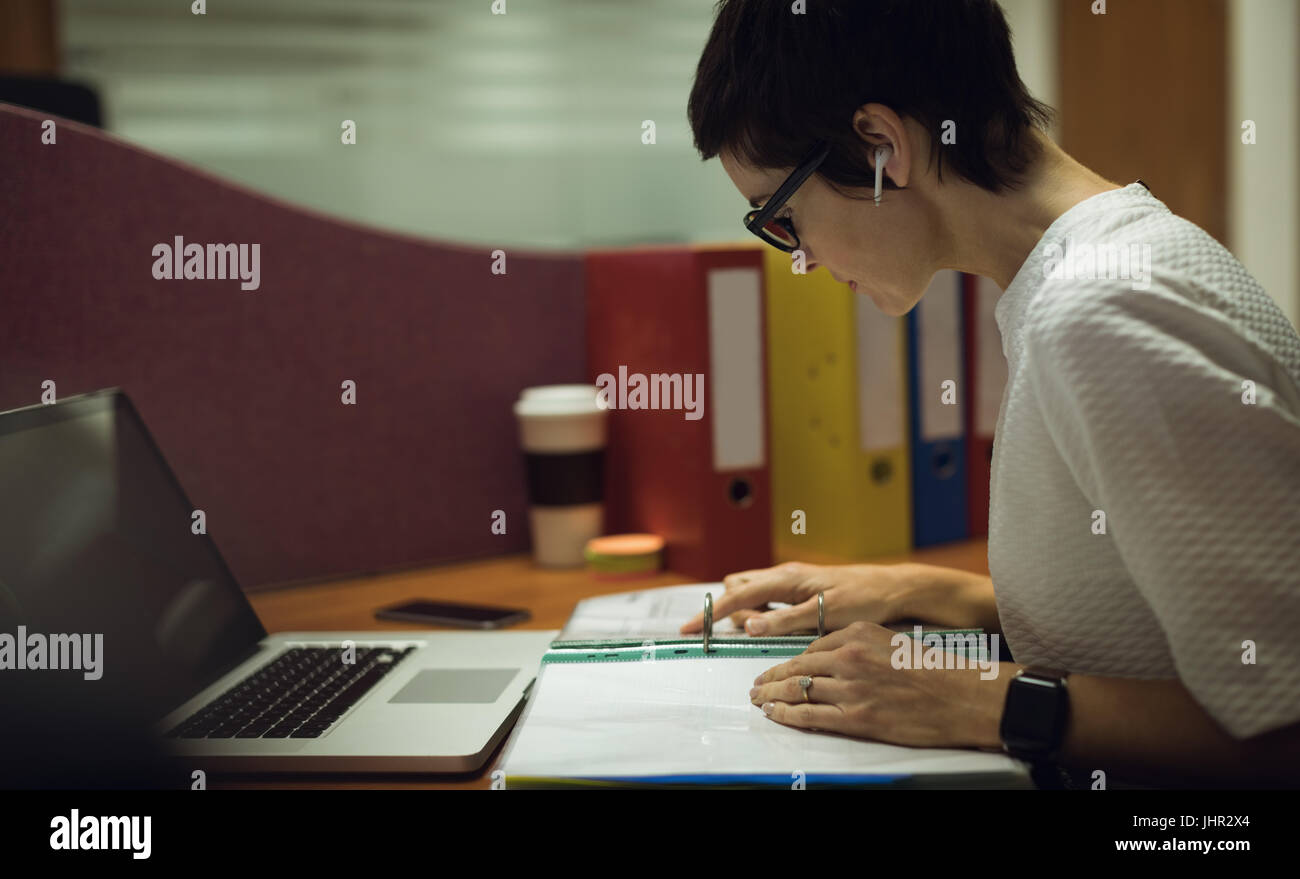 Businesswoman working at her desk in office Stock Photo - Alamy