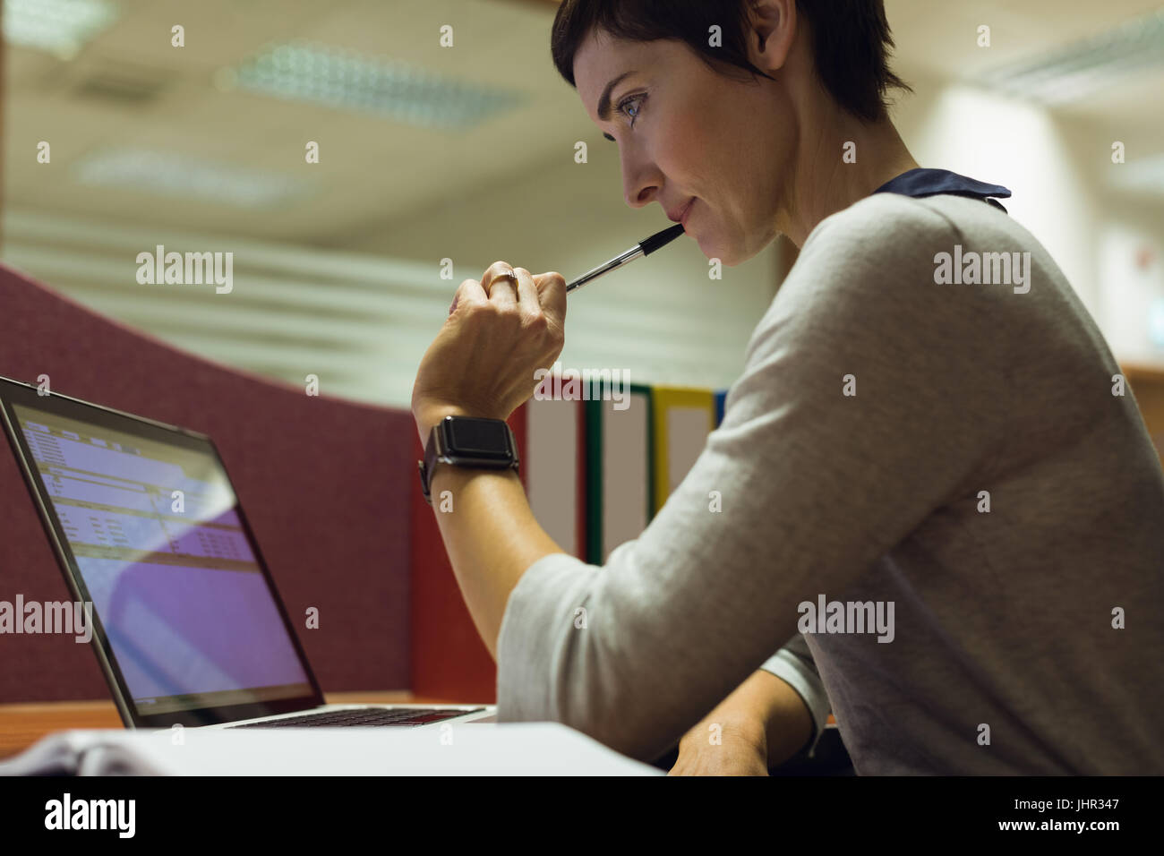 Businesswoman working at her desk in office Stock Photo - Alamy