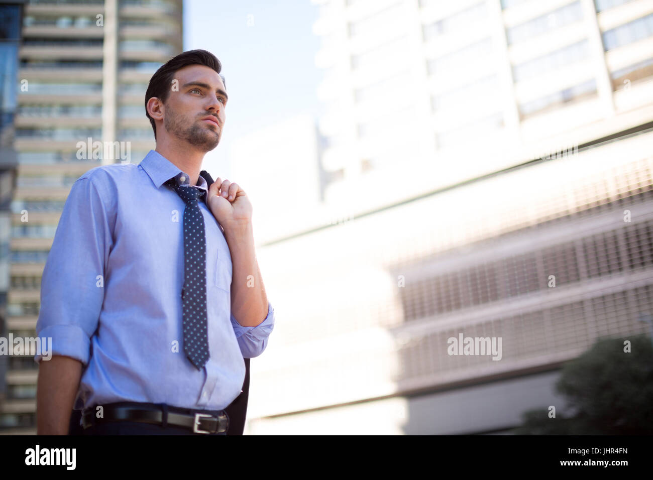 Businessman standing near office building hi-res stock photography and ...
