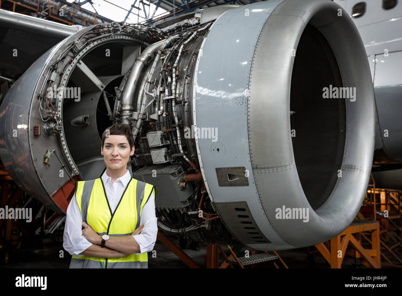 portrait of female aircraft maintenance engineer standing aircraft maintainance engg