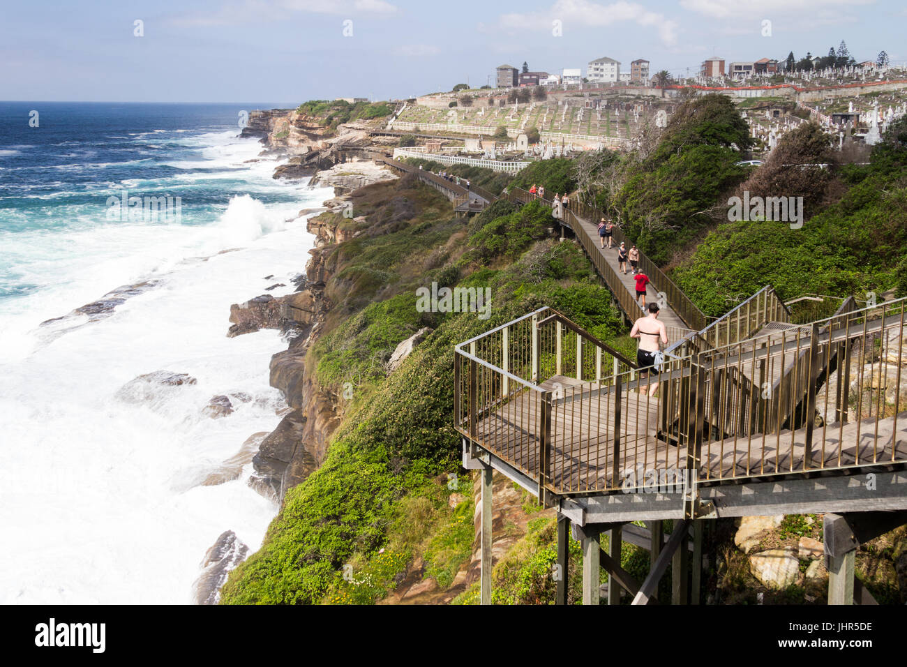 The Bondi to Coogee coastal walk with rough seas and Waerley cemetery in the background, Sydney, New South Wales, Australia, Stock Photo