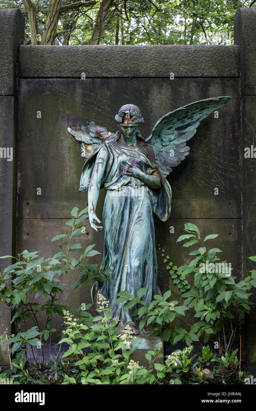 damaged sculpture of a female angel statue  on cemetery Stock Photo