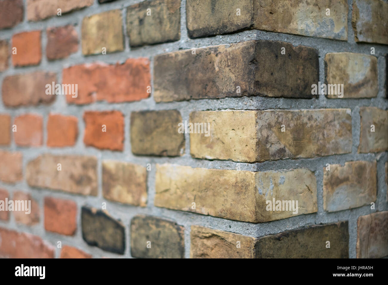 Corner of a vintage brick wall -  stone brick wall edge Stock Photo