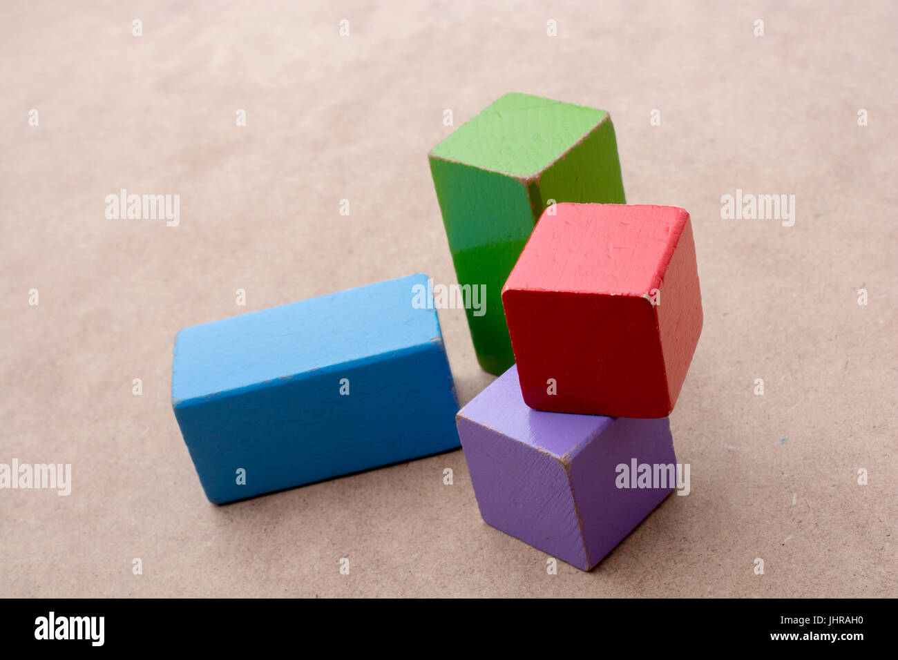 Colorful building blocks on a brown background Stock Photo - Alamy