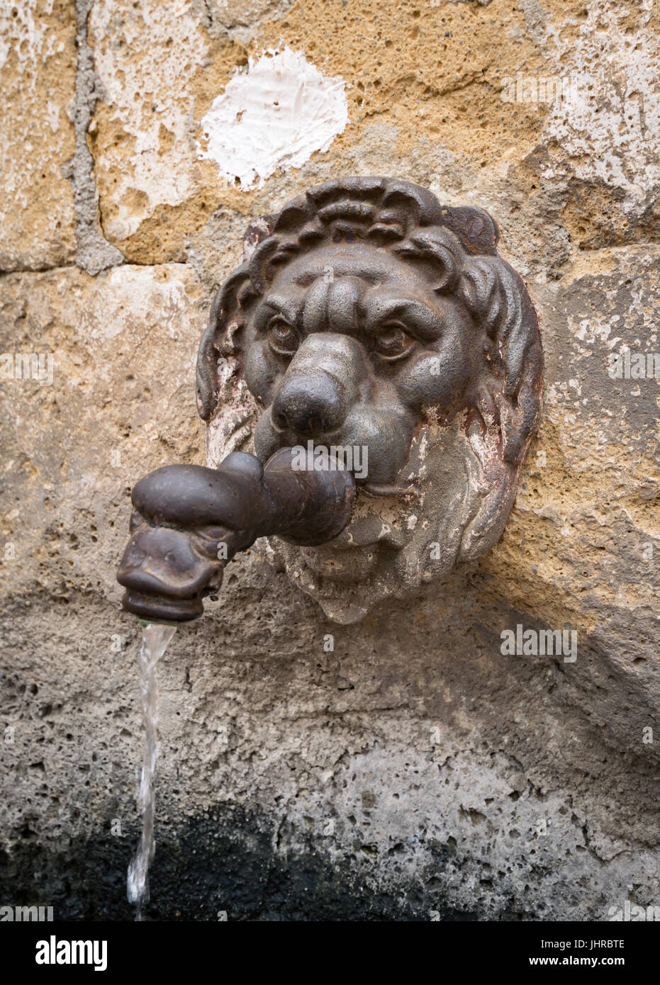 Ancient fountain in the shape of a lion's head Stock Photo - Alamy
