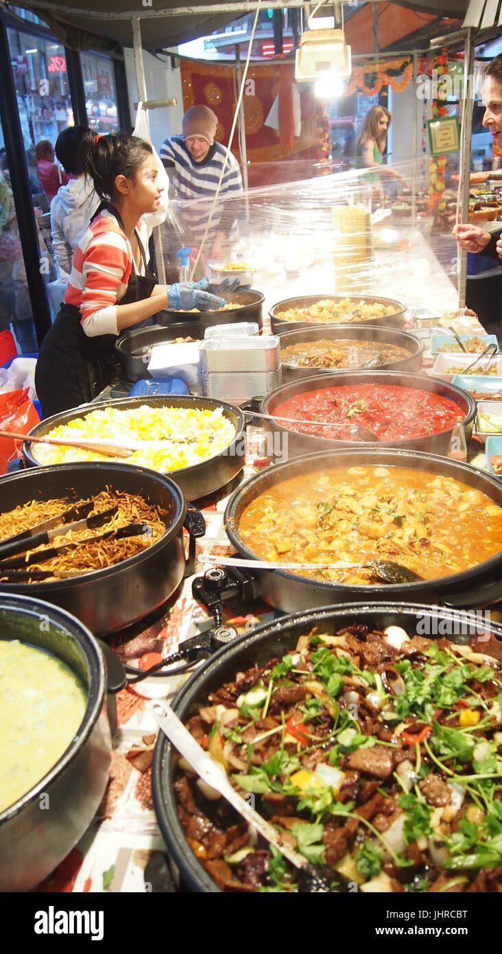 London, UK - October 6, 2013: Street food market where this Malaysian food stall cooks up fresh curries and stir frys for customers. Stock Photo
