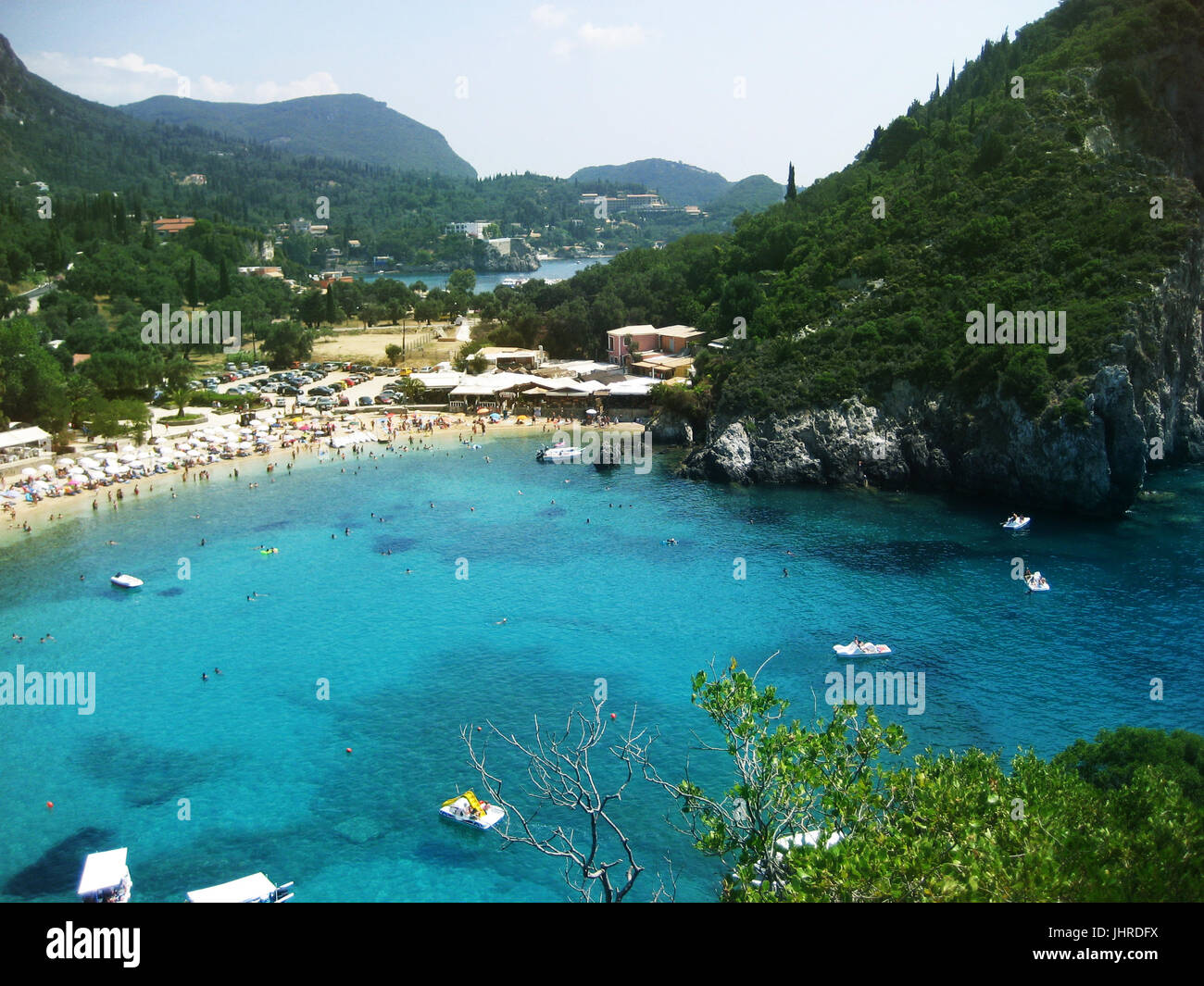 A crowded summer beach against the blue sea, top view Stock Photo - Alamy