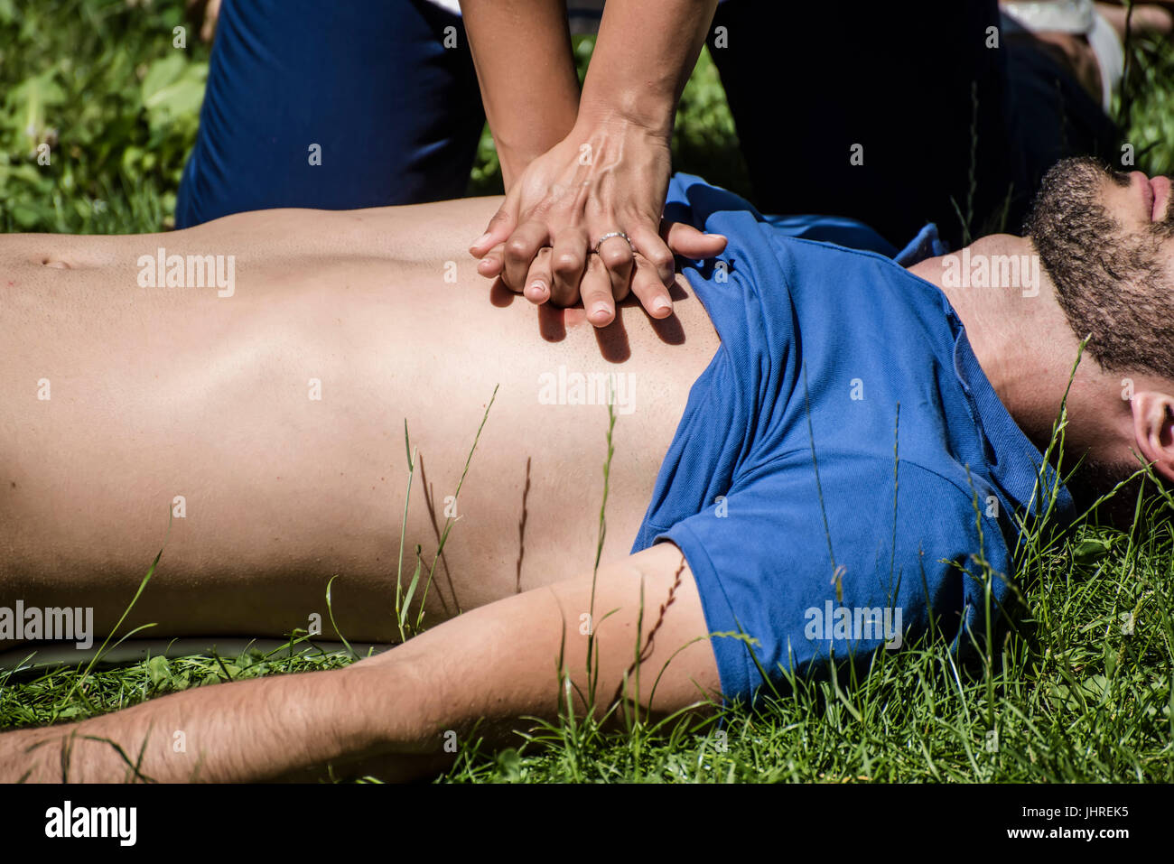 Girl Making Cardiopulmonary Resuscitation To An Unconscious Guy After