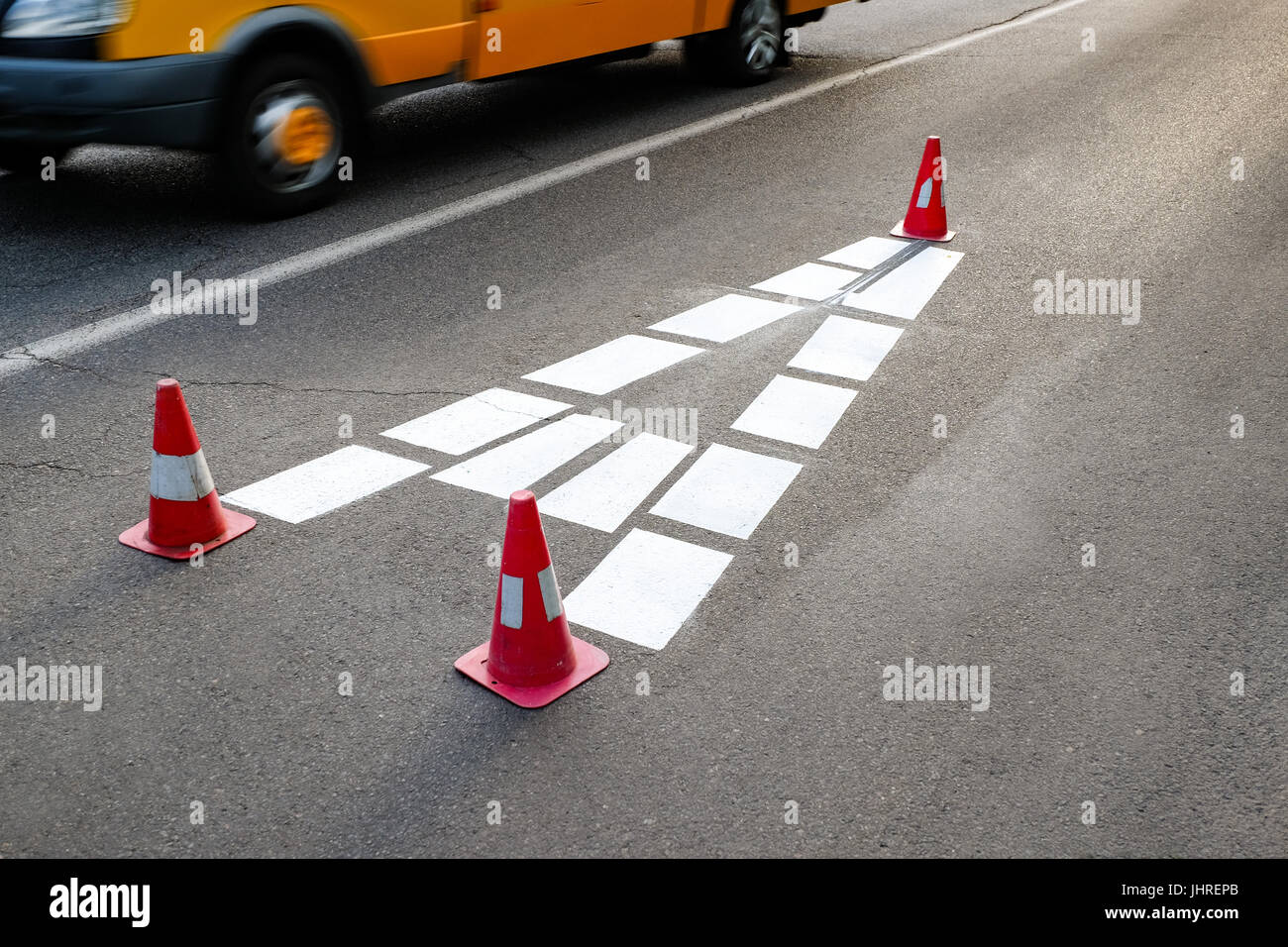 The white sign on the road Bus lane in the form of a big capital letter A painted with safety cones Stock Photo