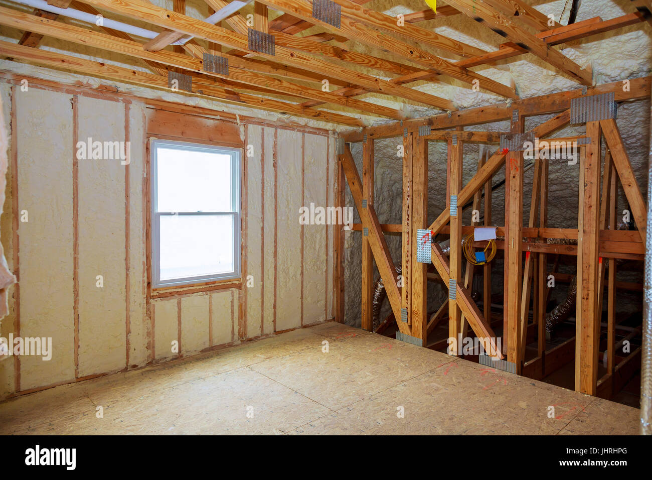 Foam plastic insulation installed in the sloping ceiling of new frame