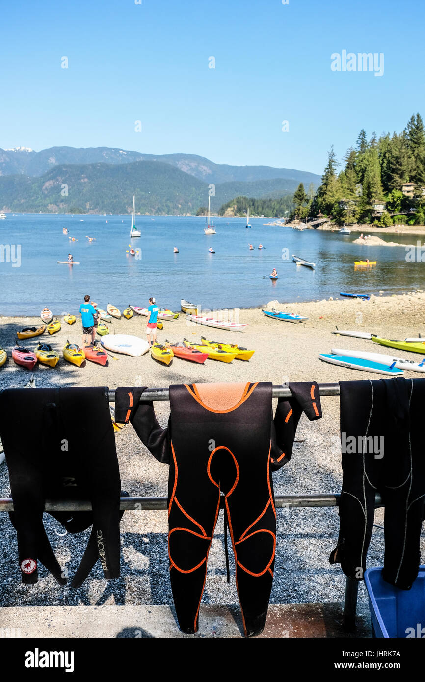 Three wet suits hanging on a railing at Panorama Park at Vancouver, British Columbia, Canada