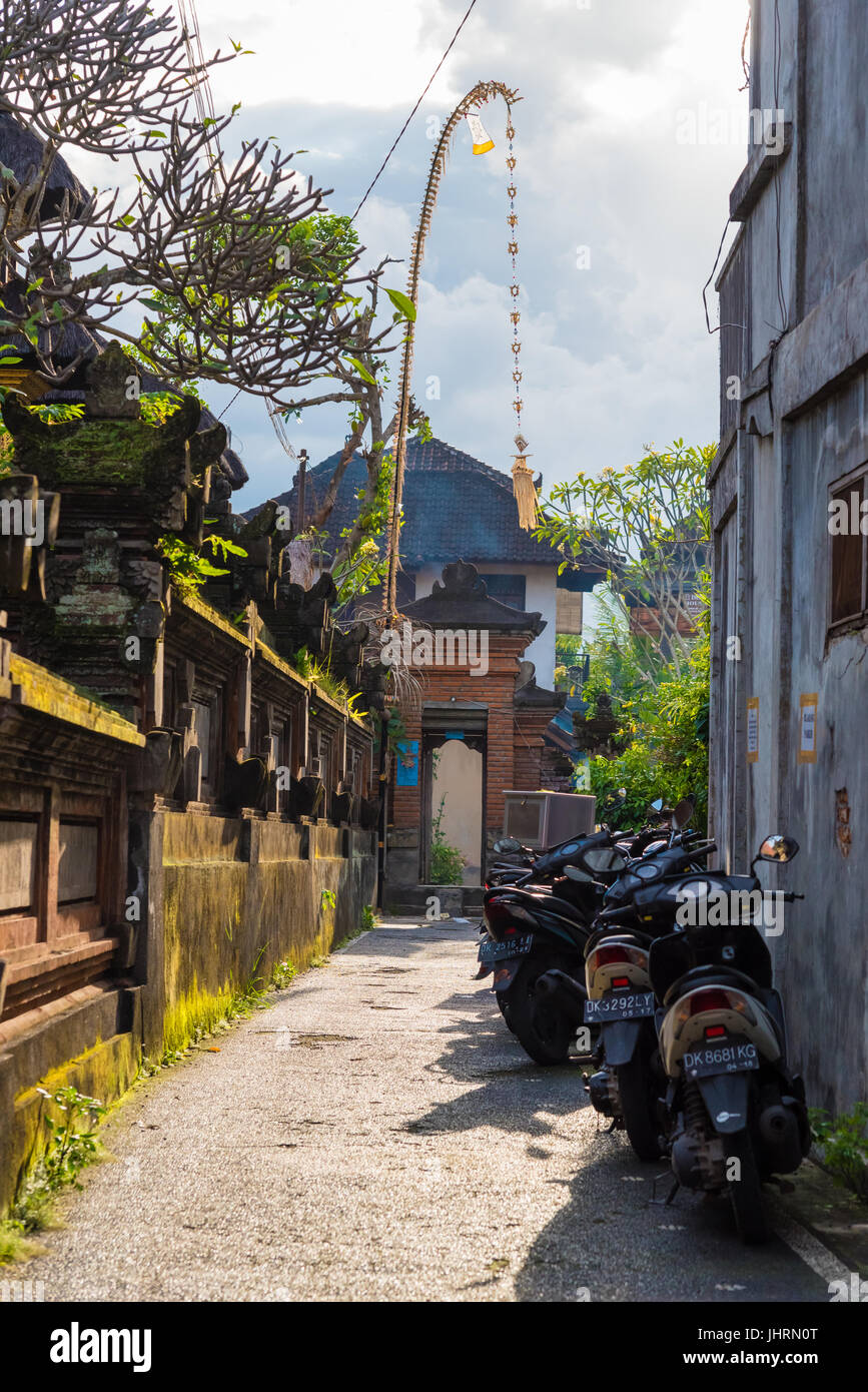 Ubud, Bali, Indonesia - May 6, 2017 : View of traditional narrow street in Ubud, known worldwide as a centre for Balinese culture, arts and crafts Stock Photo