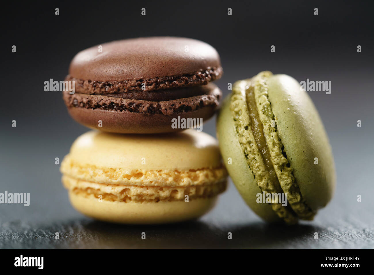 three assorted macarons on slate board Stock Photo