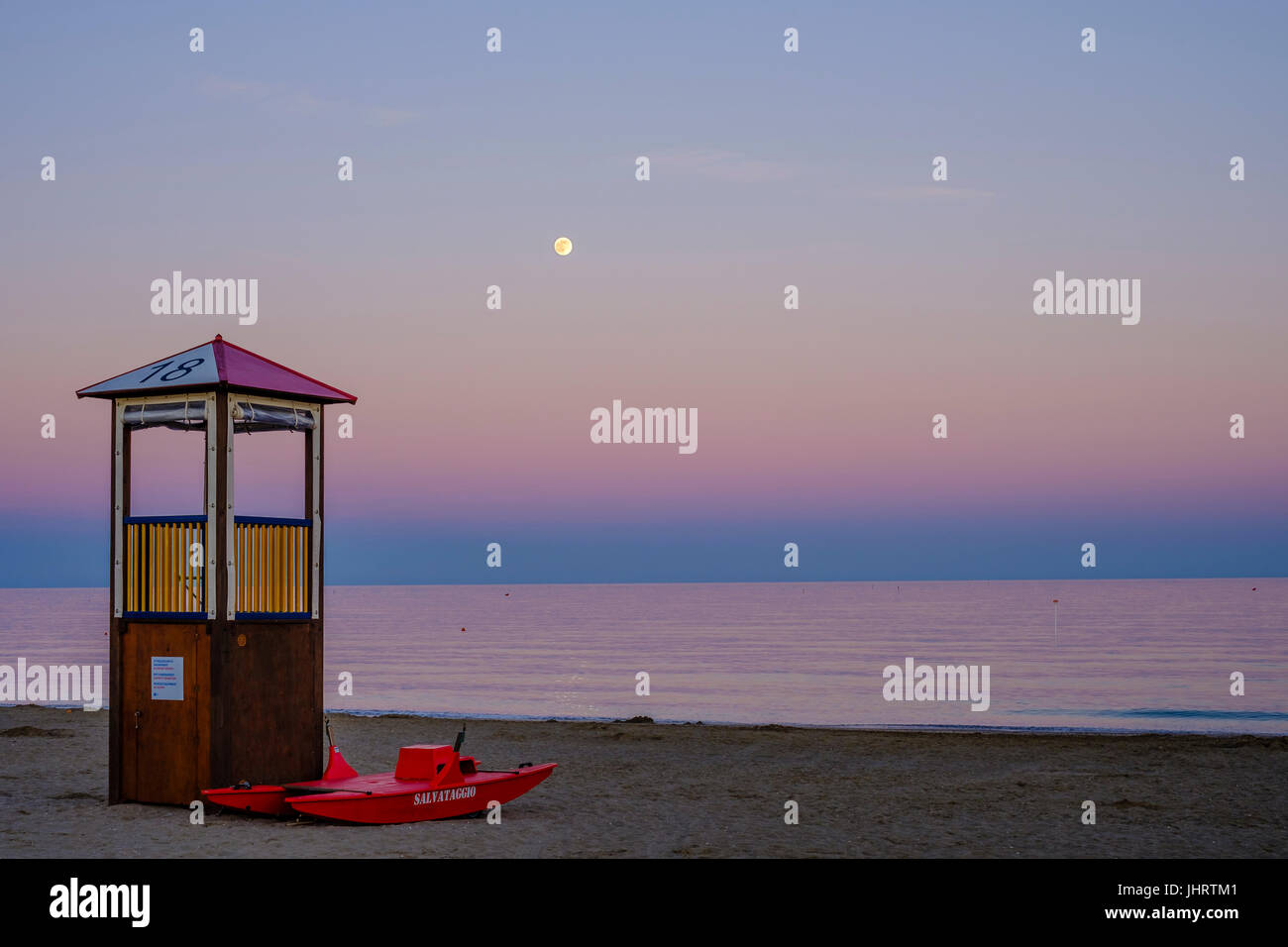 Rescue tower and rescue boat on the beach, evening mood, Adriatic Sea, Italy Stock Photo