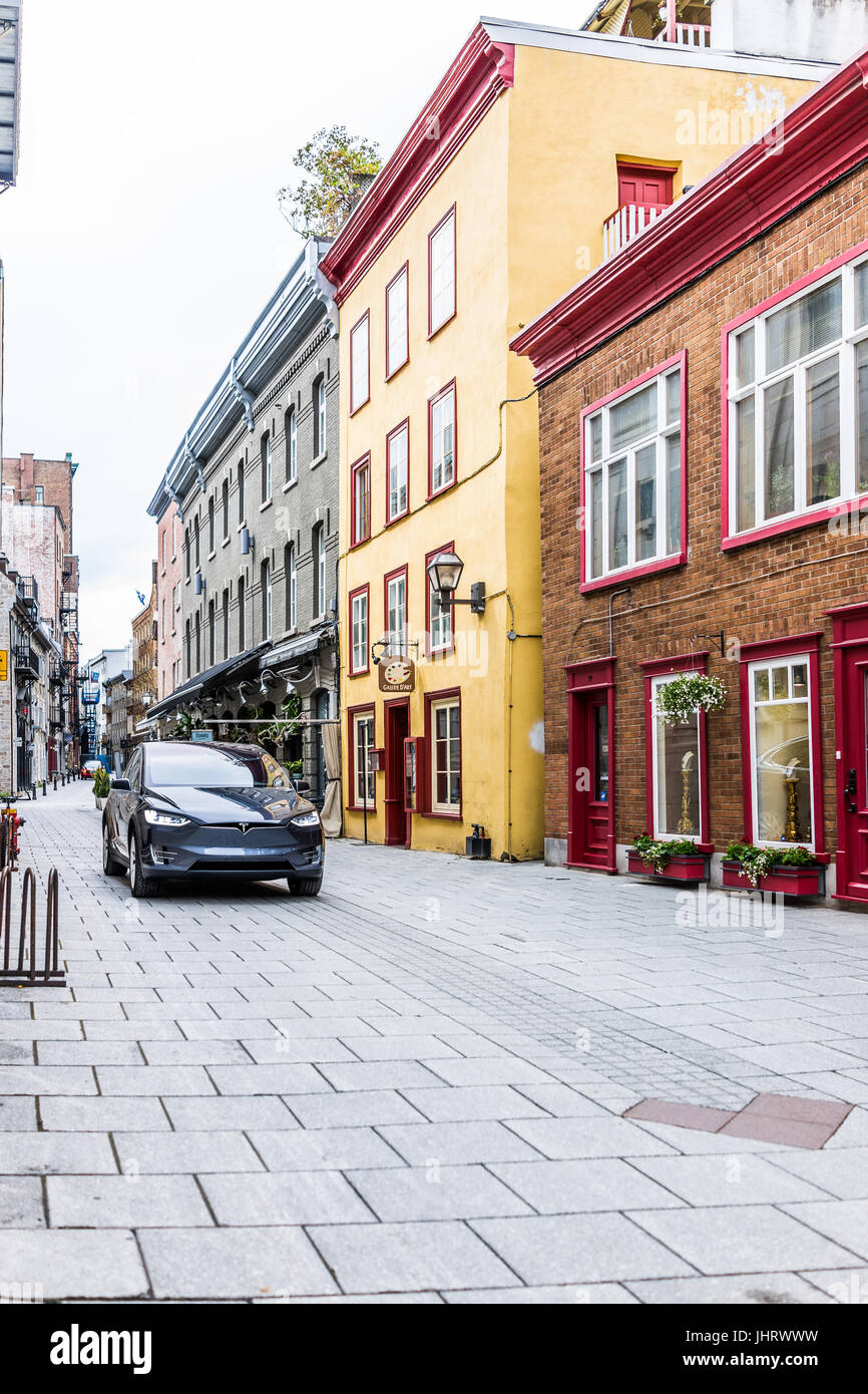 Quebec City, Canada - May 30, 2017: Blue Tesla Model X driving on cobblestone road in lower old town street called rue Sault-au-Matelot by restaurants Stock Photo