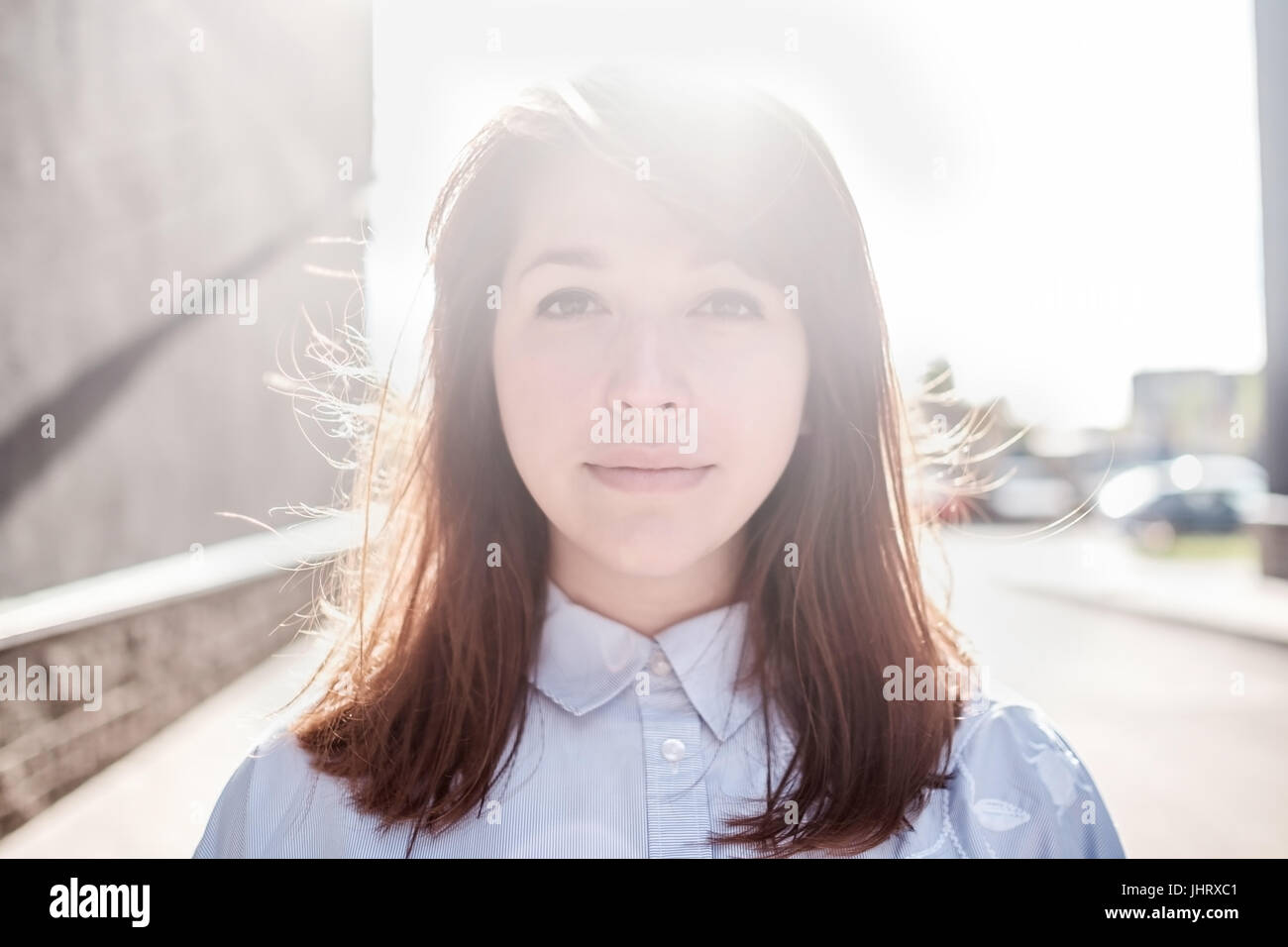 Beautiful woman portrait outdoors with back light. Stock Photo