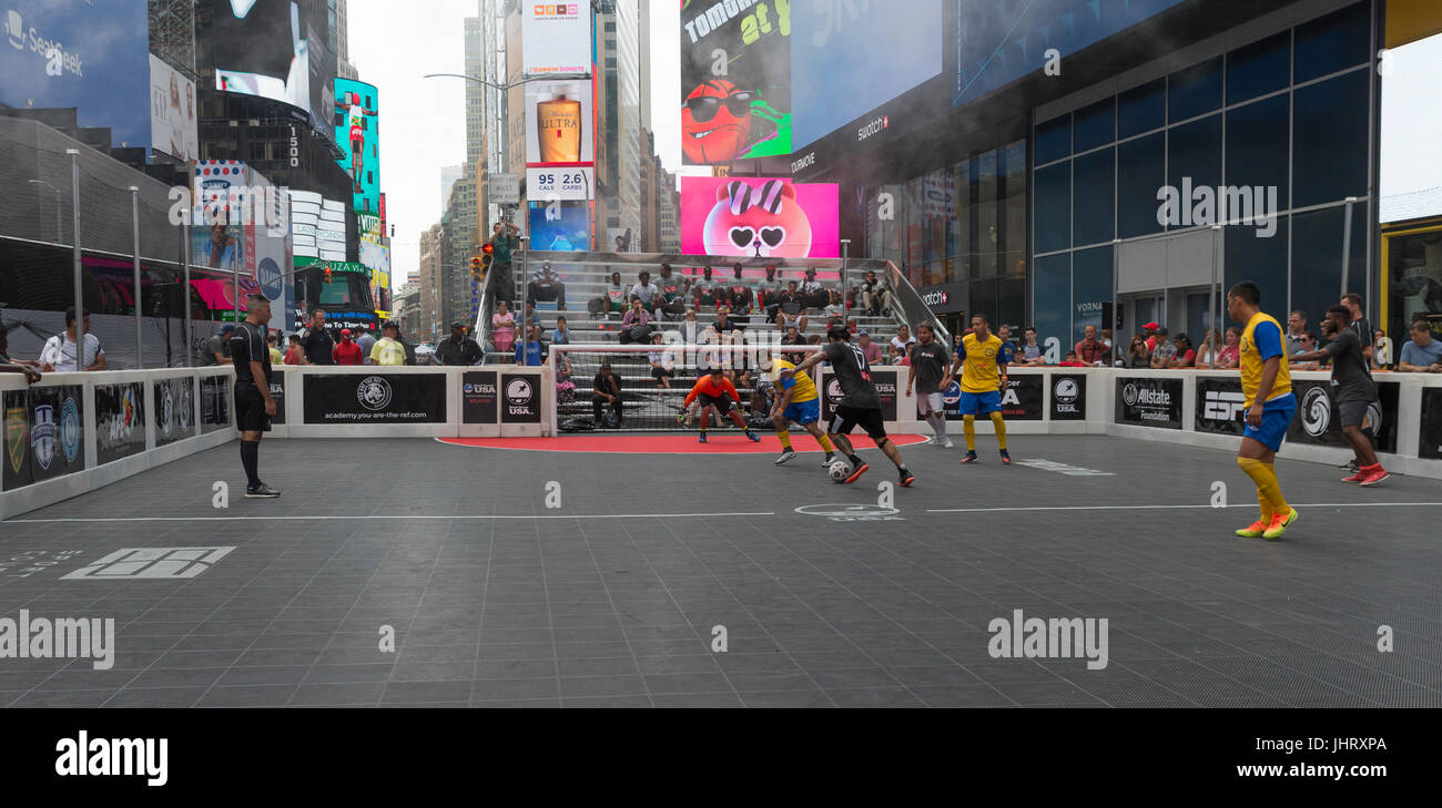 New York, NY USA - July 15, 2017: SPG (grey shirts) and NY Ecuador (yellow shirts) teams playing during US Street Soccer NYC Cup 2017 event on Times Square spg lost 4 - 13 Stock Photo