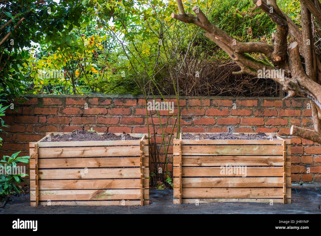 Two wooden compost bins in a back garden Stock Photo Alamy