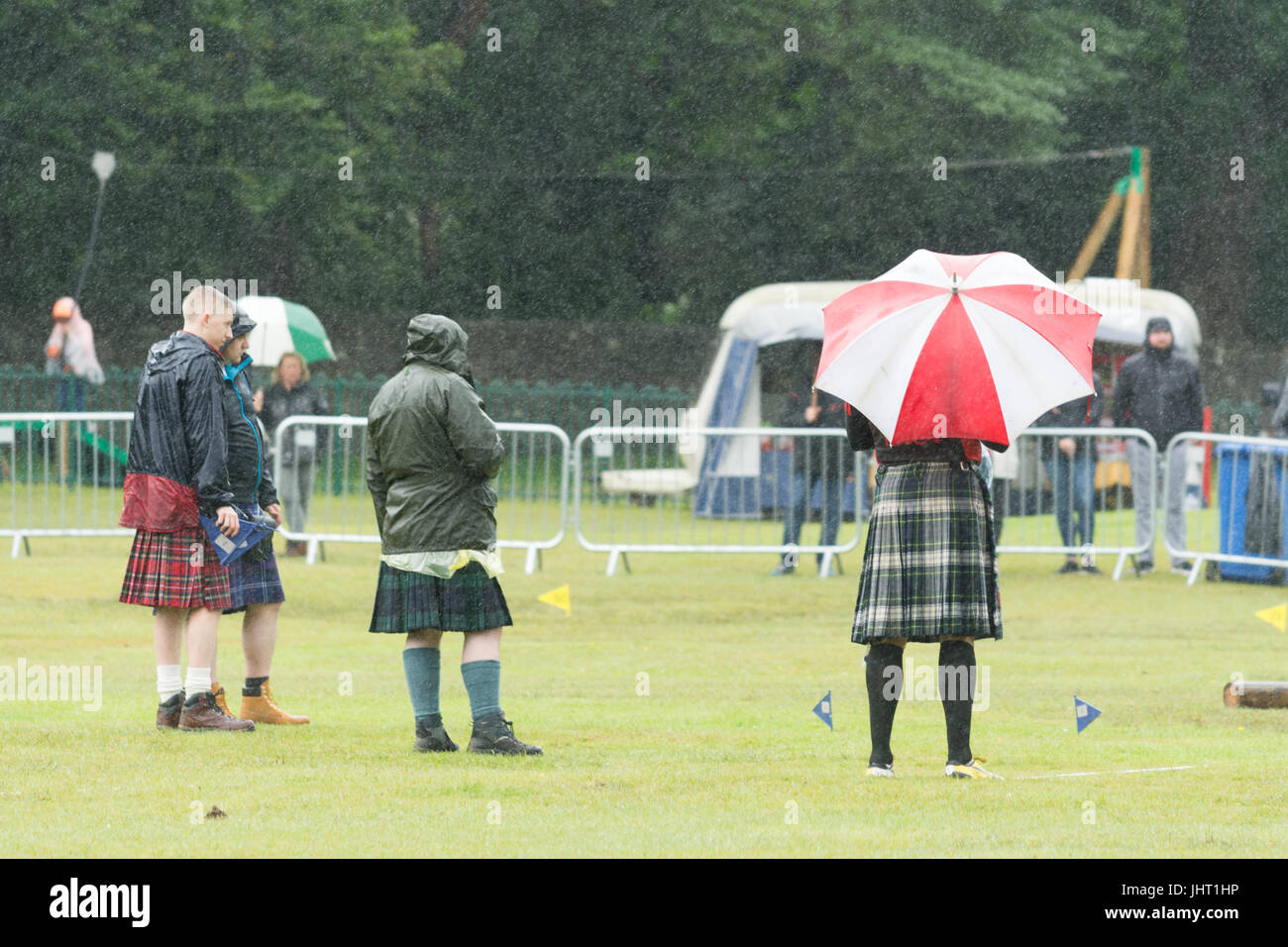 Balloch, Loch Lomond, Scotland, UK. 15th July, 2017. UK weather - competitors faced very wet conditions at the Loch Lomond Highland Games. The Loch Lomond Games annual event is now in its 51st year and includes the Scottish Highland Games Association Official World Heavyweight Championship as well as local sporting competitions. Credit: Kay Roxby/Alamy Live News Stock Photo