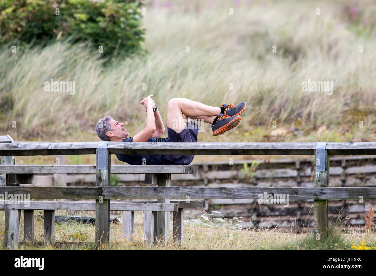 Southport, Merseyside, 16th July 2017. UK Weather.   A beautiful sunny start to the day over the north west coast of Englland as a man warms up for hid morning exercises on Southport beach in Merseyside.  With spells of gorgeous sunshine forecast to continue throughout the day, a lovely day is expected over the popular seaside resort.  Credit: Cernan Elias/Alamy Live News Stock Photo