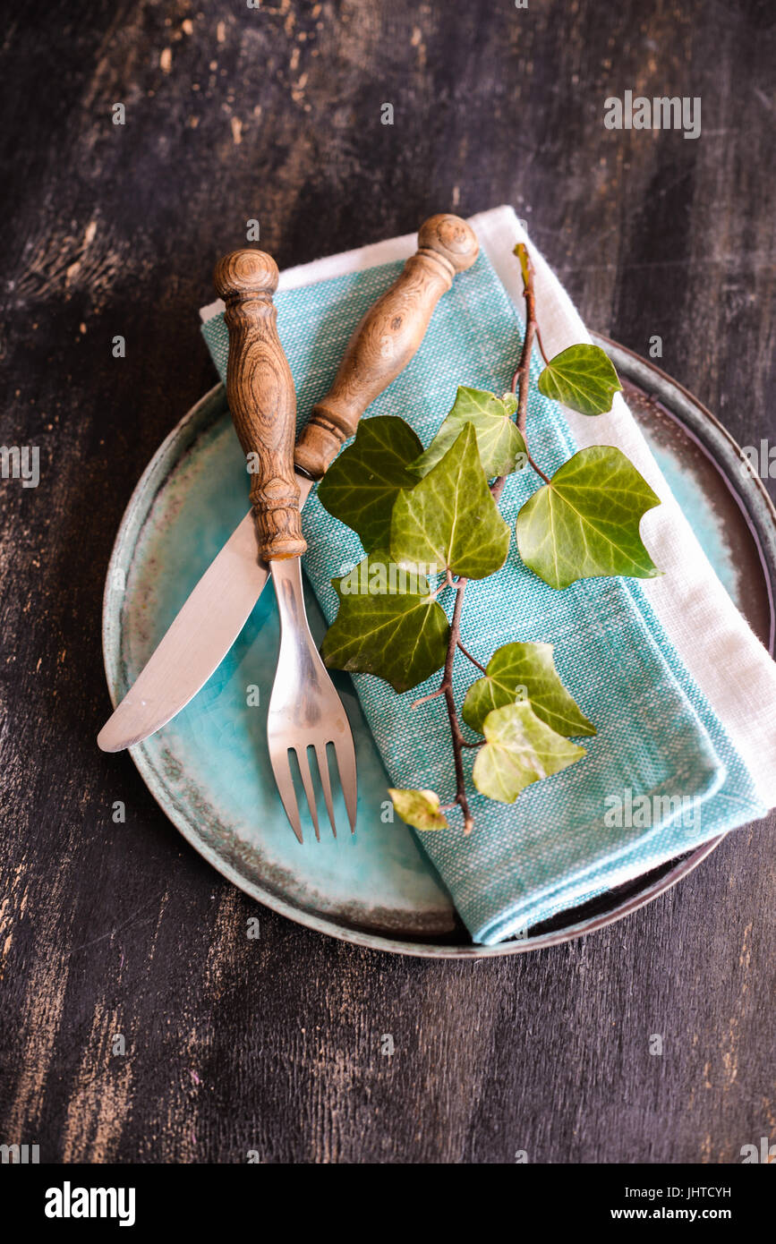 Rustic Table Setting With Wild Grape Leaves On The Plate On Dark Wooden