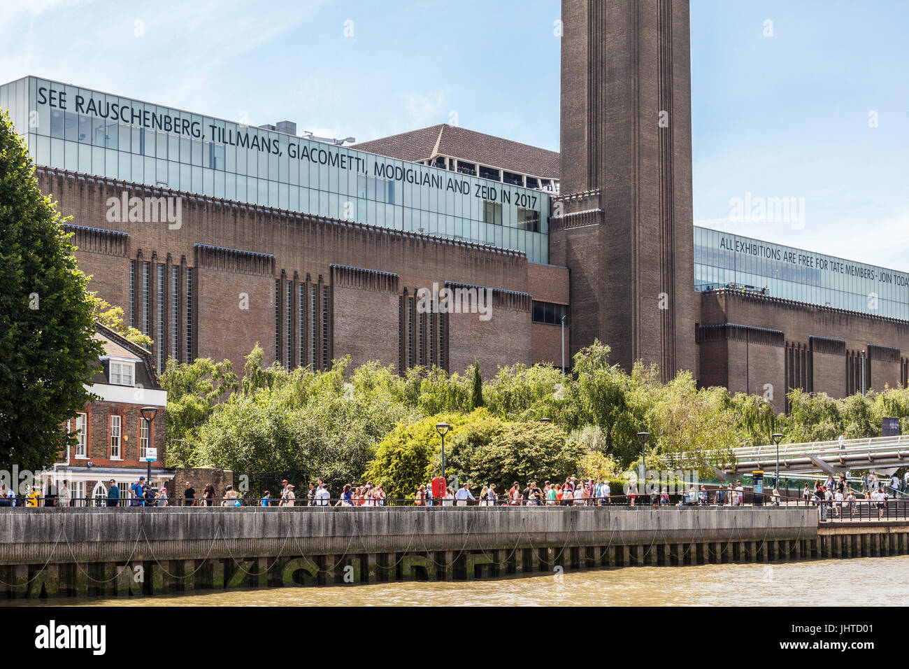 Tourists and locals on Bankside, in front of the Tate Modern on a hot summer day in central London, England, UK. Stock Photo