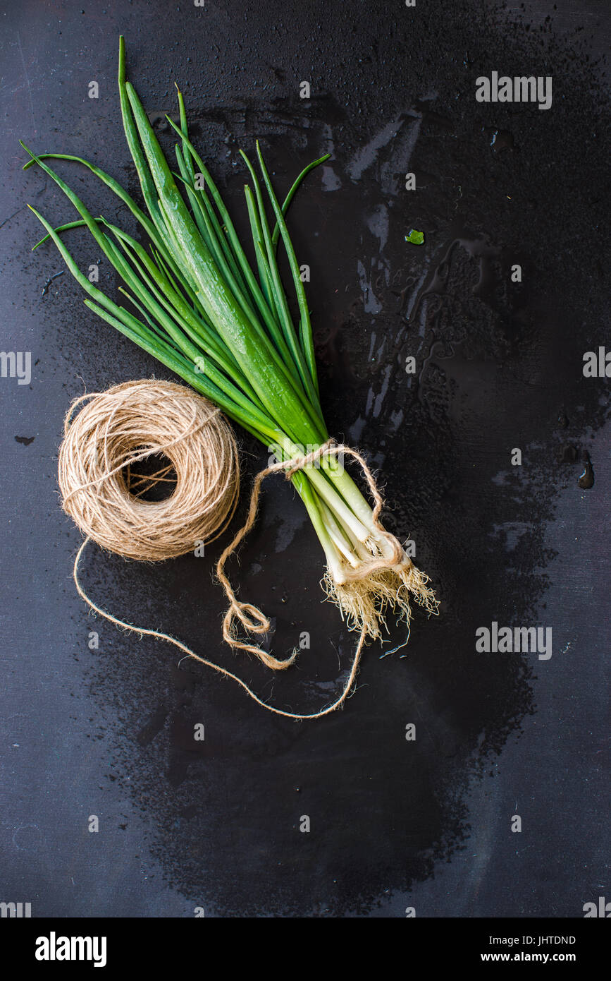 Organic green onion on dark board Stock Photo - Alamy