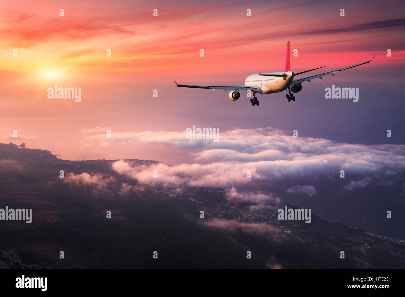 Airplane. Landscape with big white passenger airplane is flying in the ...